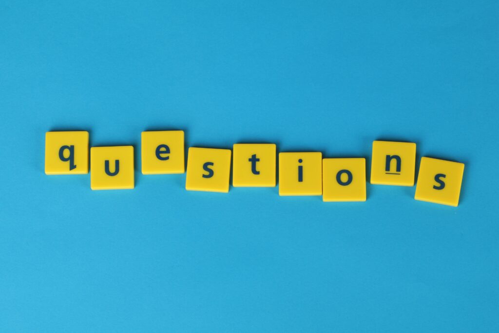 Yellow letter tiles spell 'questions' on a contrasting blue background.